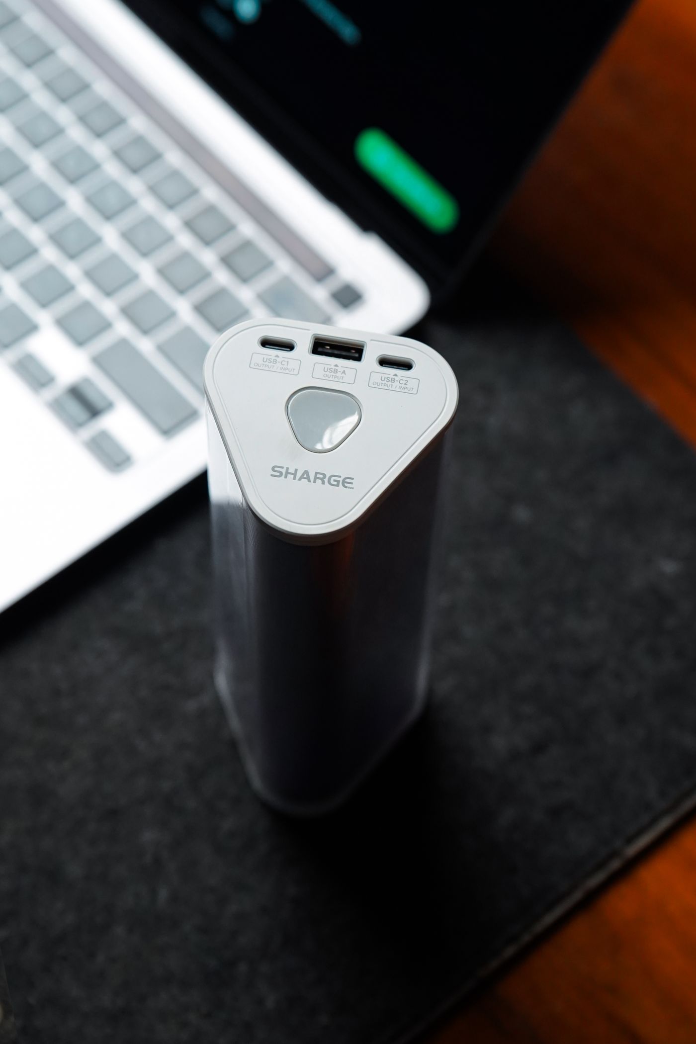 Power station charging a laptop and devices on a desk